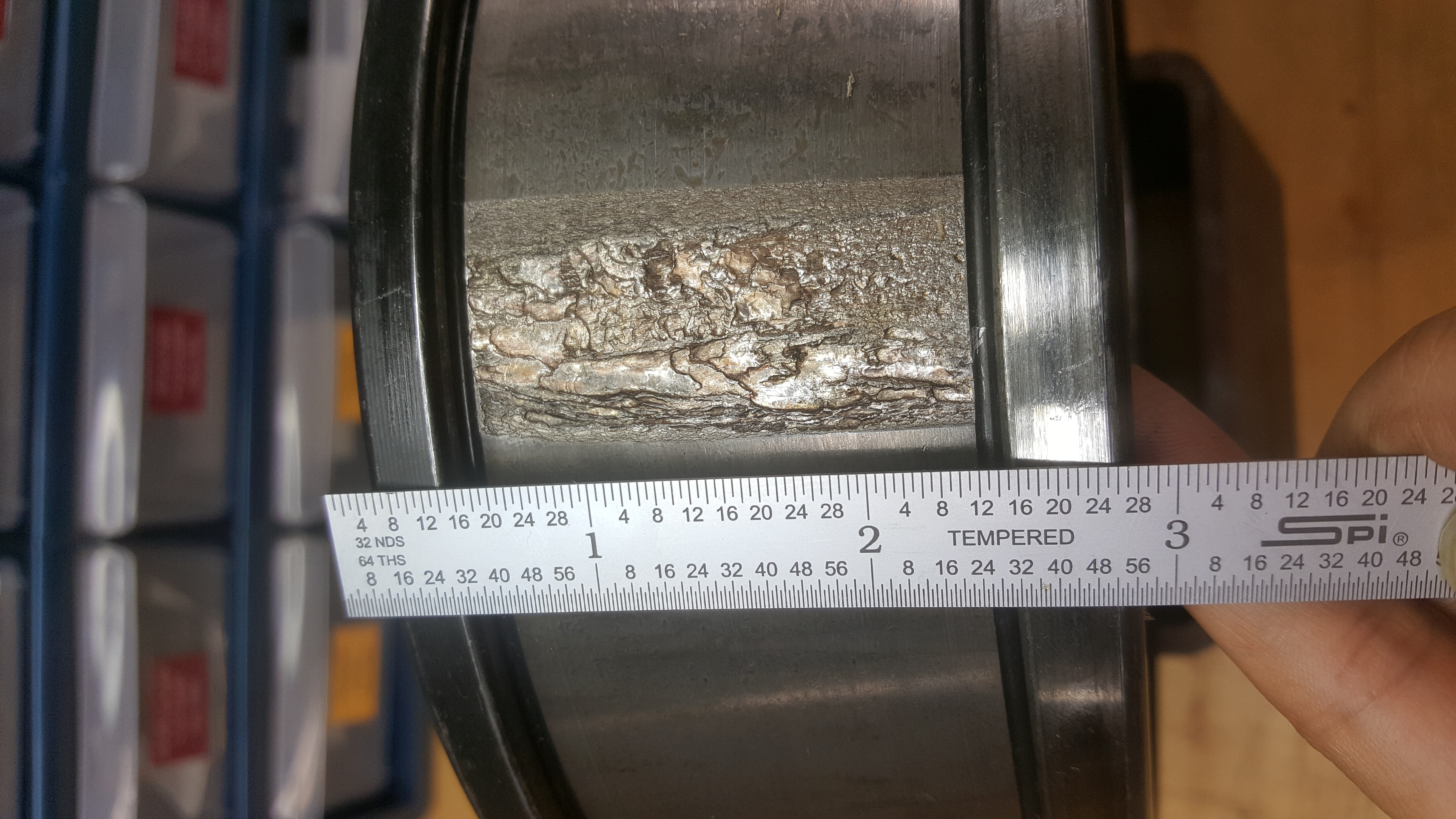 A spall of size 1.63 in² on a cup.